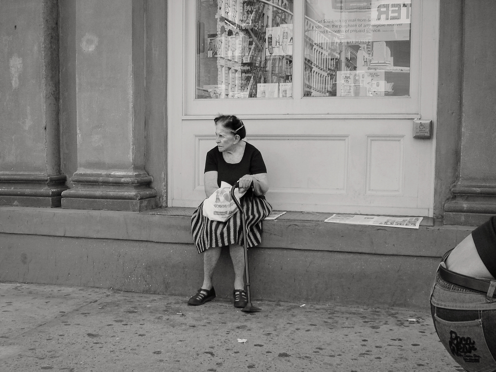 Christoph Radke, New York City, an elderly lady sitting on a doorstep, 2005